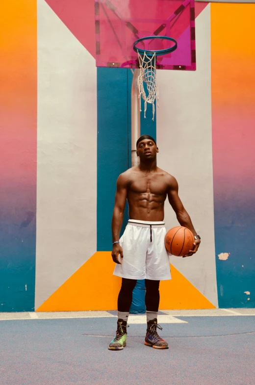 a man standing in front of a colorful basketball court