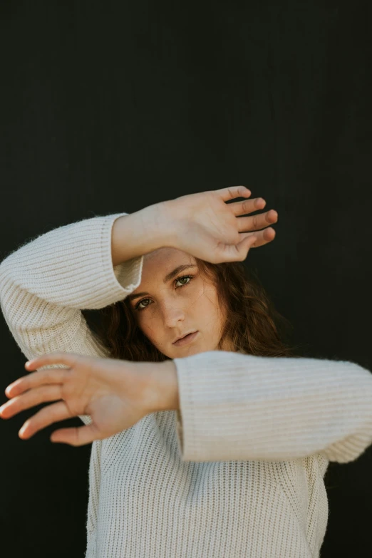 a woman stretching her arms with her hands