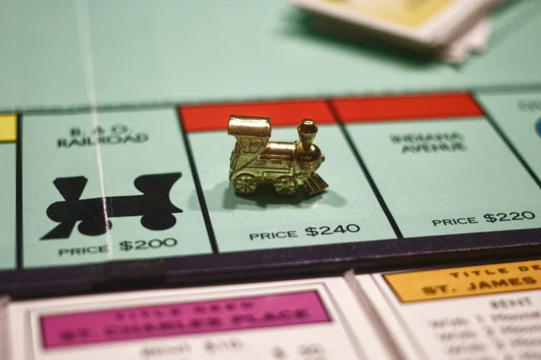 a monopoly board with a toy car sitting on top