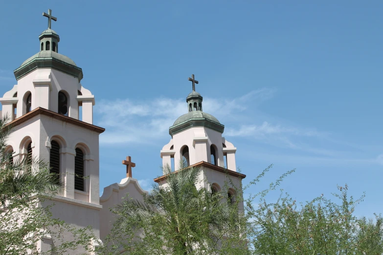 some very large white buildings with towers and crosses