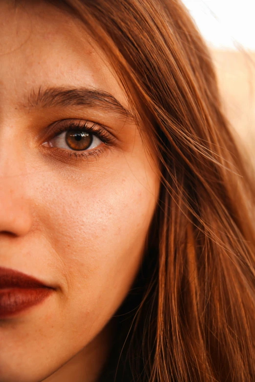 a woman is holding her hair back with an elegant brown lip