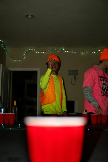 three people wearing neon clothes standing around