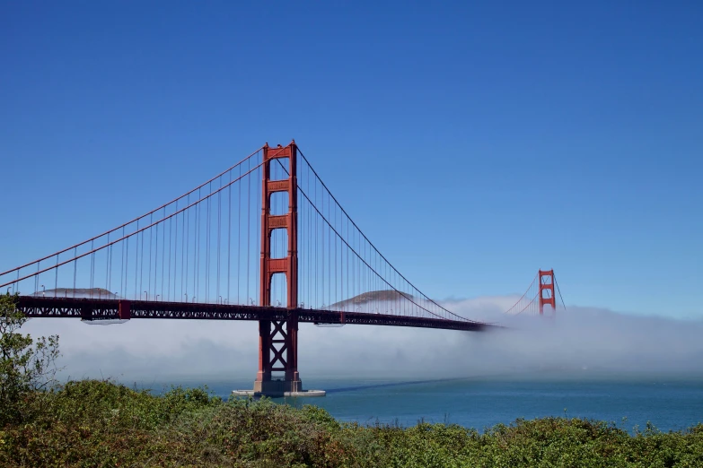 a very tall bridge by the ocean with a very tall tower