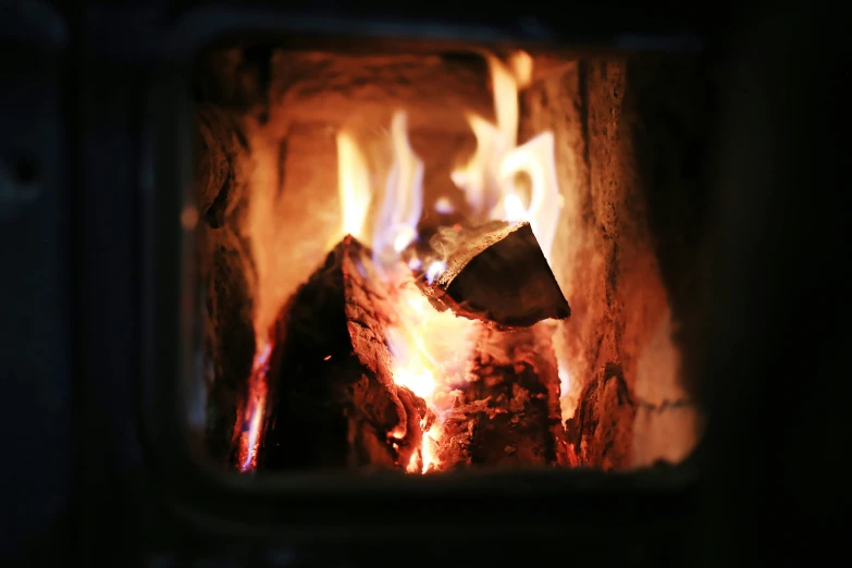 a fire burning inside of a stone oven