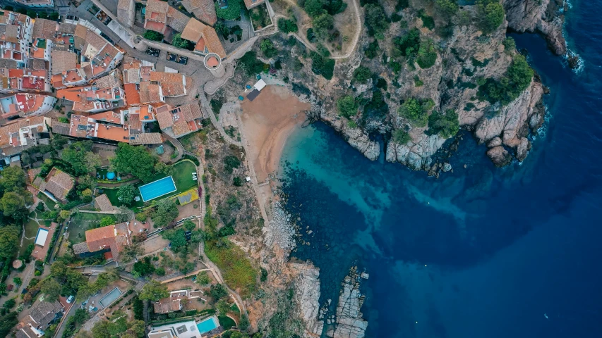 an aerial view of the town of porto with water and trees surrounding it