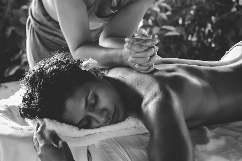 woman receiving massage while sitting in spa