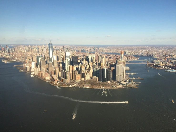 an airplane flies over the lower manhattans as it heads towards queens harbor