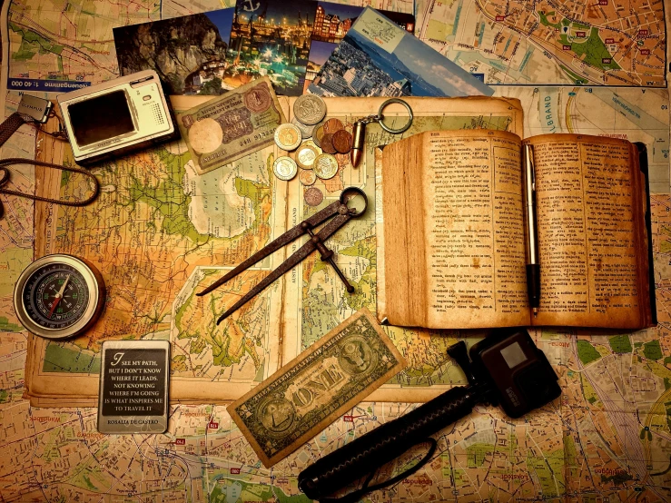 a map, books, and other assorted items are arranged on the table