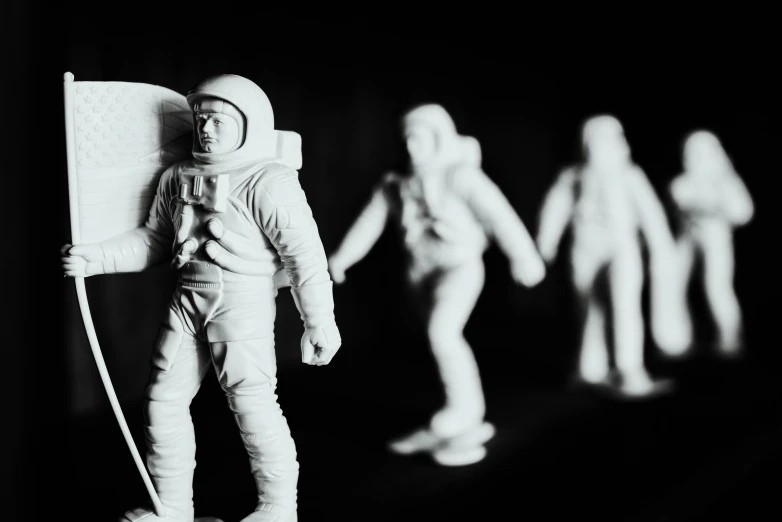 small white plastic people in spaces with an object