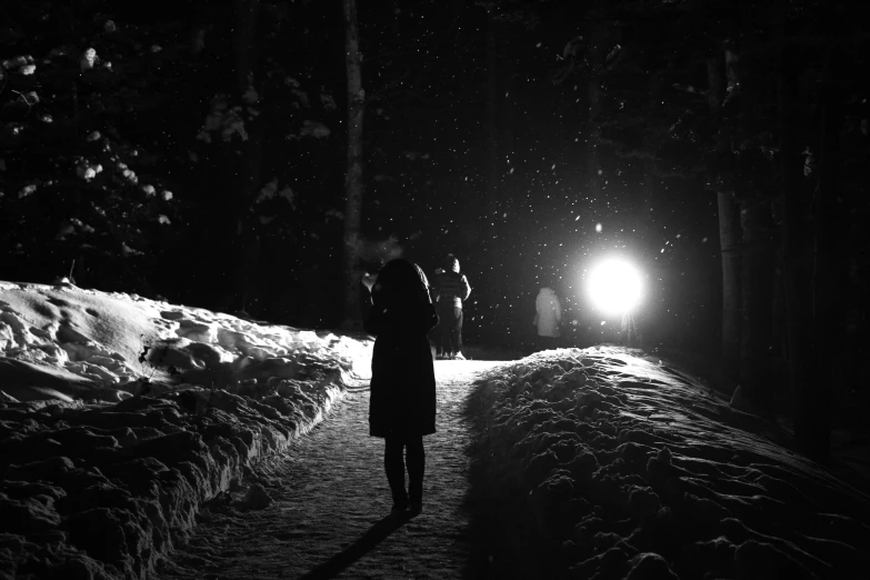 two people standing on a path with snow around