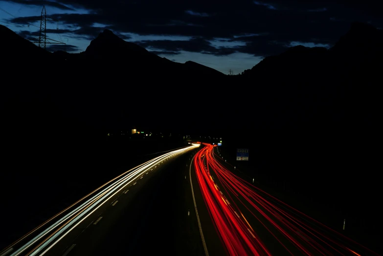car lights are seen on a highway at night