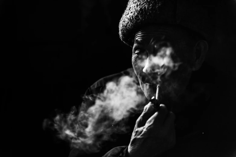 a woman smoking soing with smoke coming out of her mouth