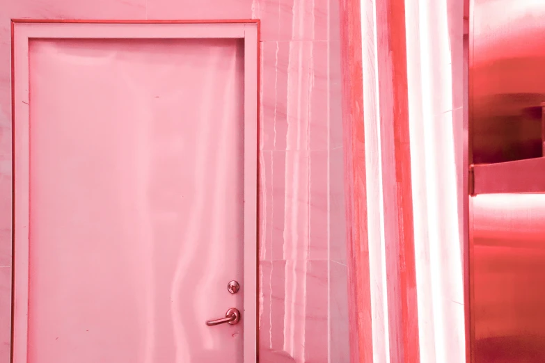 a red door with a striped pink wall