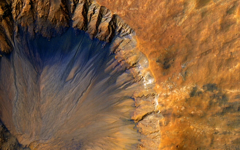 a large mountain surrounded by barren land with dirt on it