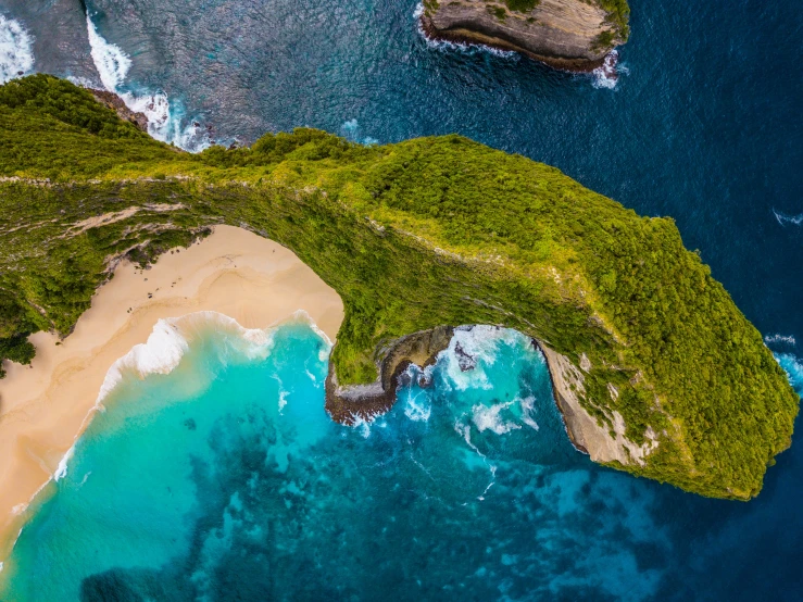 an aerial view of a large island and the ocean