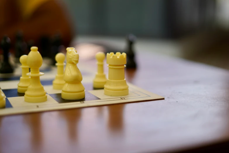chess pieces, placed on a chessboard, in front of a person