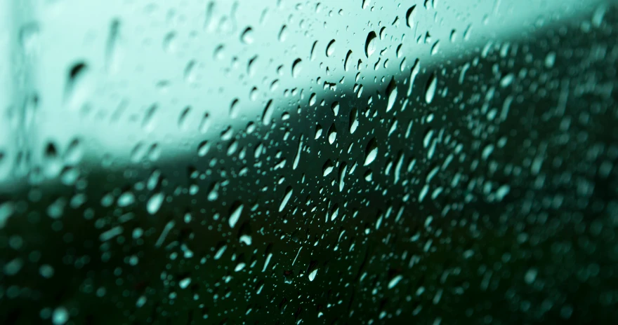 rain drops on the glass of an approaching bus