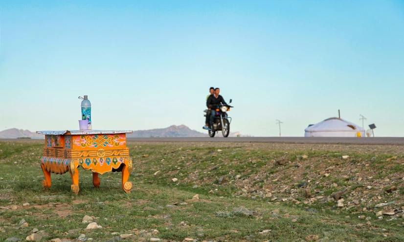 there is a man riding a motorcycle over a sign