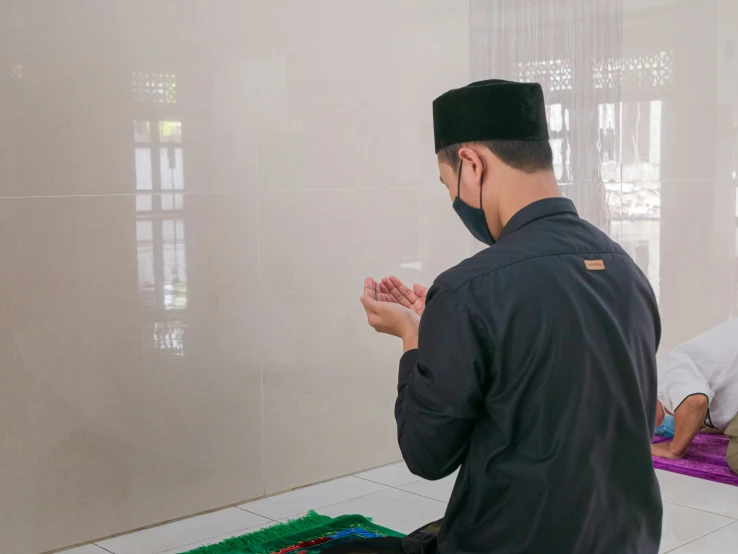 a man in the praying position in an indian - american mosque