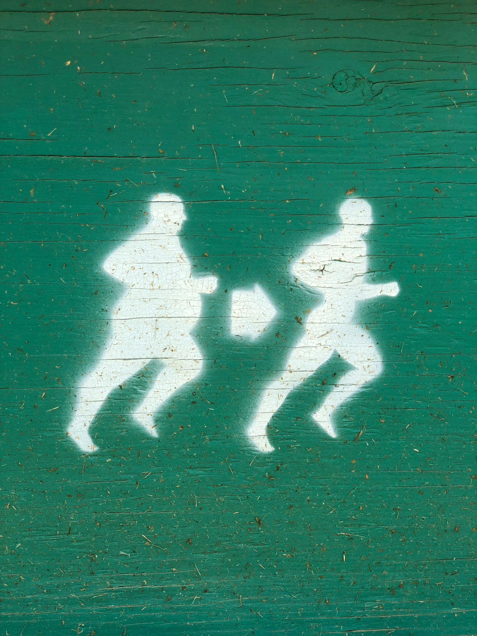 a sign with a man and woman running across it