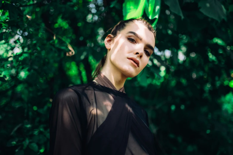 a person wearing a green headpiece looking to the side