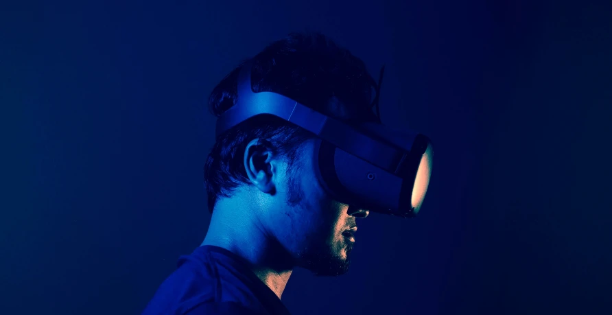 a man is standing up and wearing a pair of virtual headset