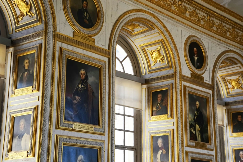 pictures of people with names and frames on the wall