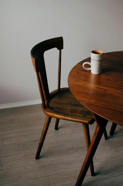 a wooden table and two chairs sitting on top of it