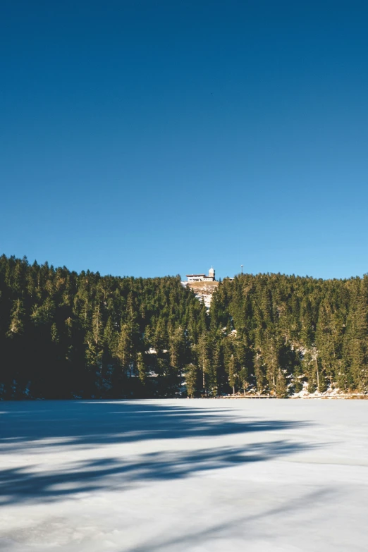 a large body of water with a small mountain in the background