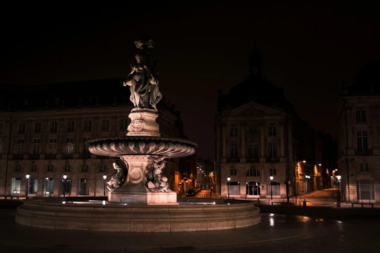 night time scene showing a building and a fountain