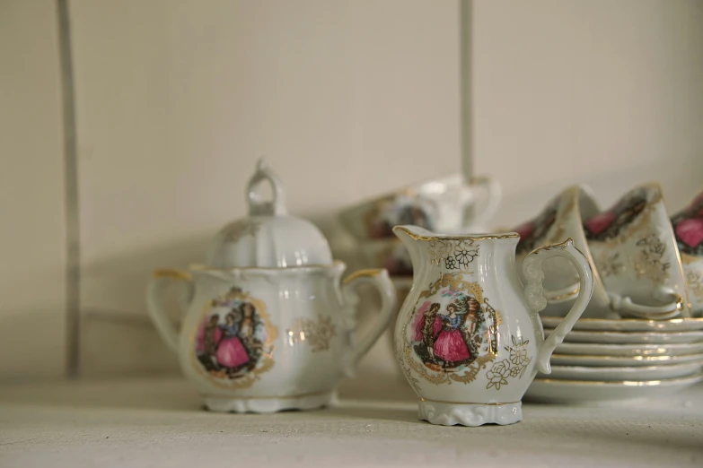 a white pitcher that is next to plates