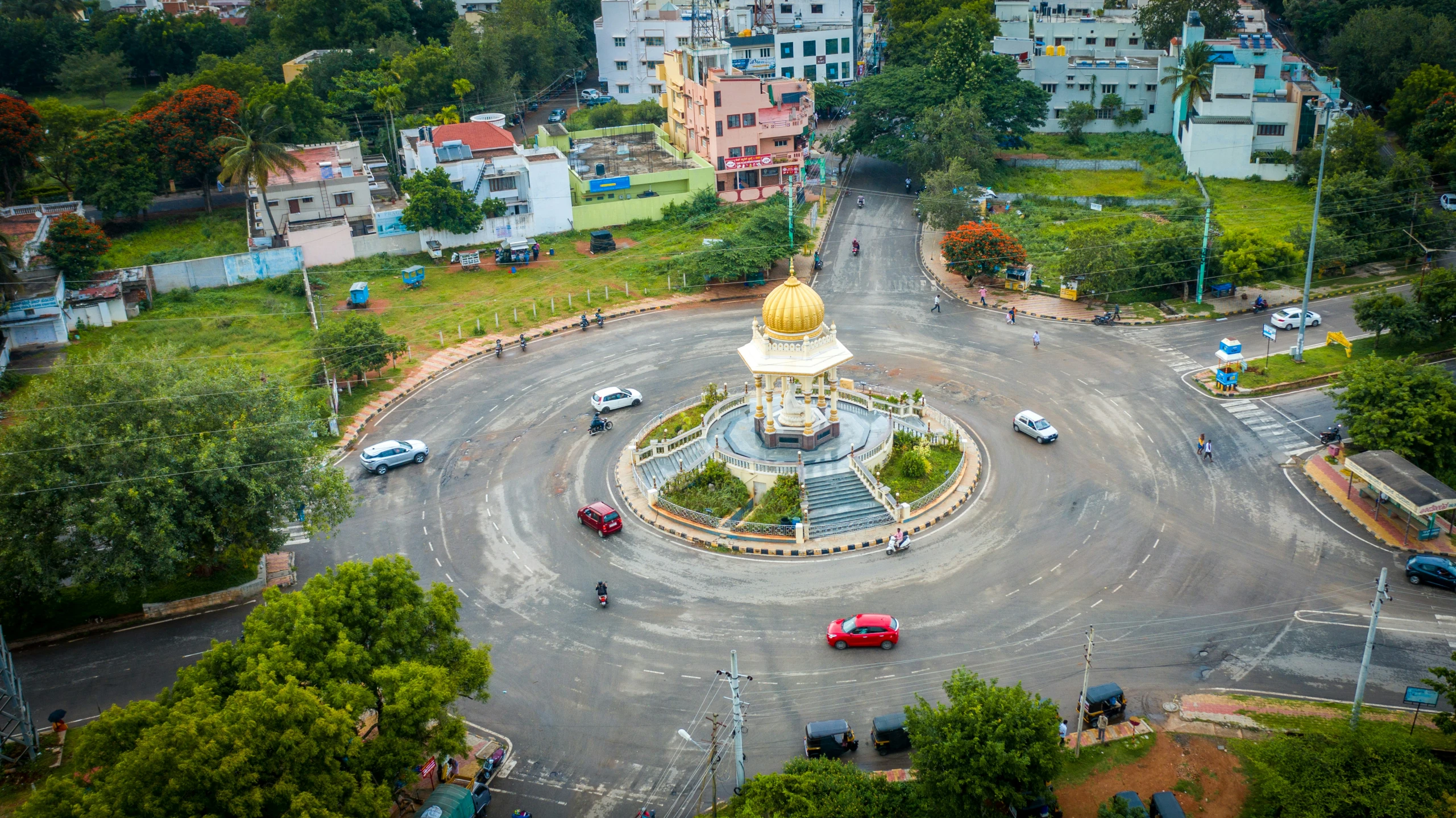 aerial view of a small clock tower with trees in the background