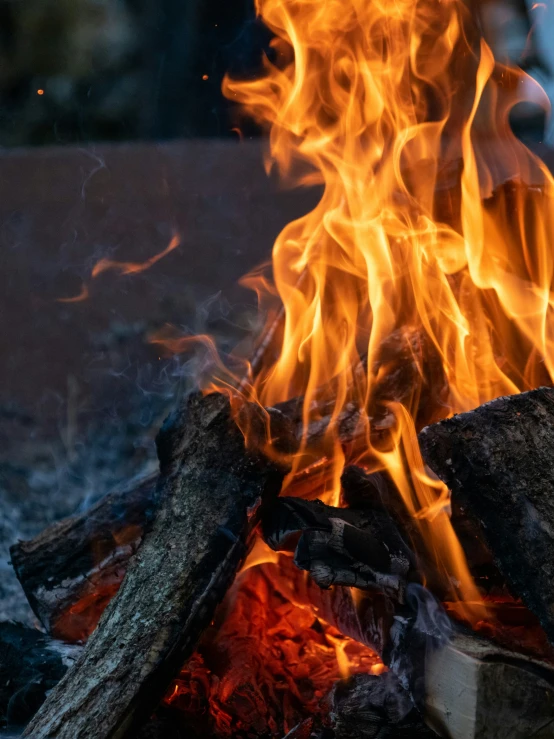 a fire burning inside of a wooden burning stove