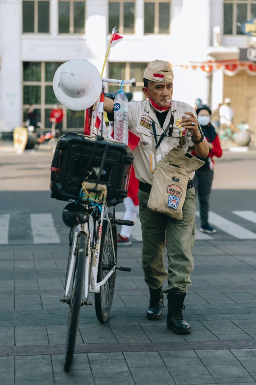 man carrying a basket and microphone next to a bike