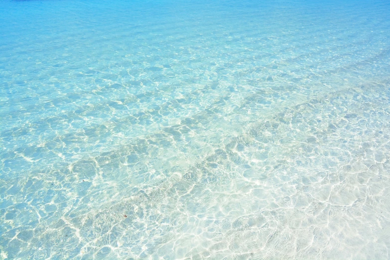 an empty boat floating in the ocean near land