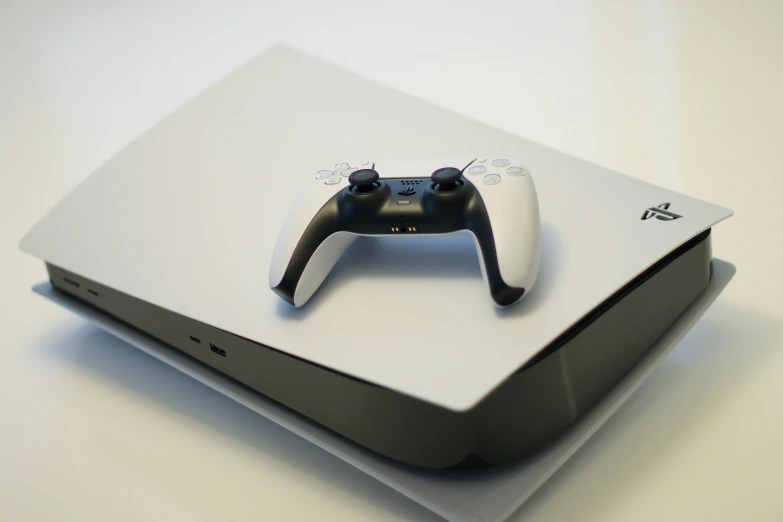 a black controller sitting on top of a white box