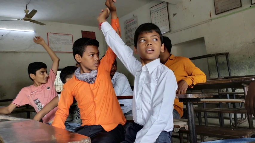 a group of children sitting around a table in a room