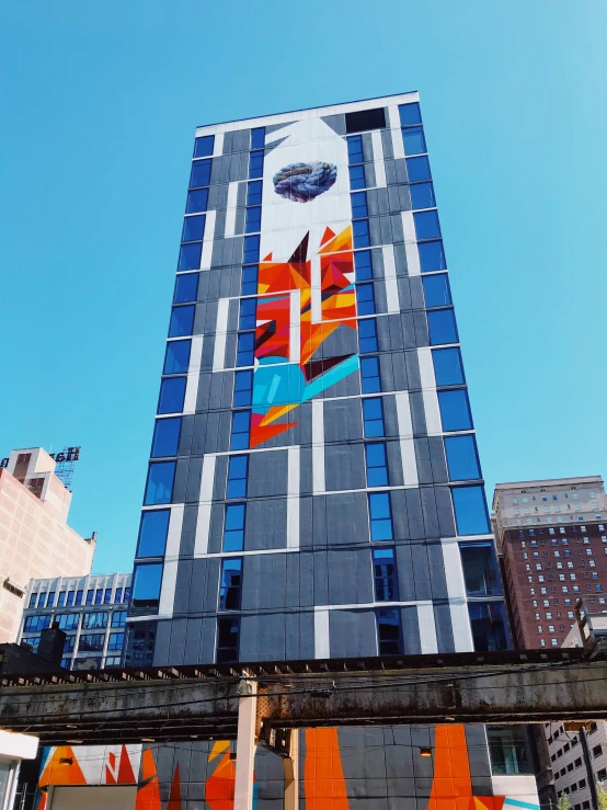 a very tall building with a colorful face painted on it