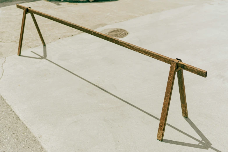 a metal bar is in the middle of an empty sidewalk