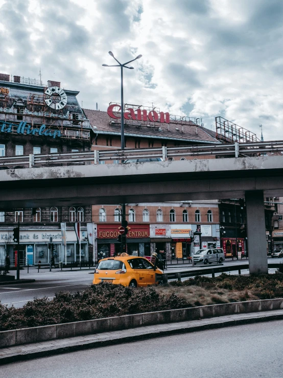 there is a taxi and other buildings along this street