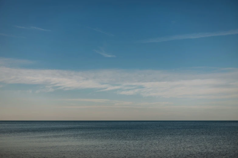 a distant boat out in the ocean on an overcast day