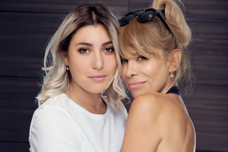 a couple of women posing together for a po