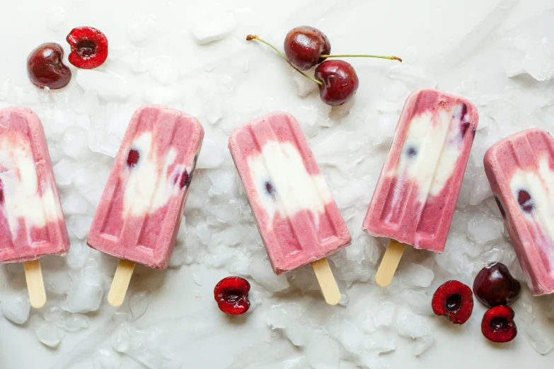 four popss made from frozen cherries and white chocolate
