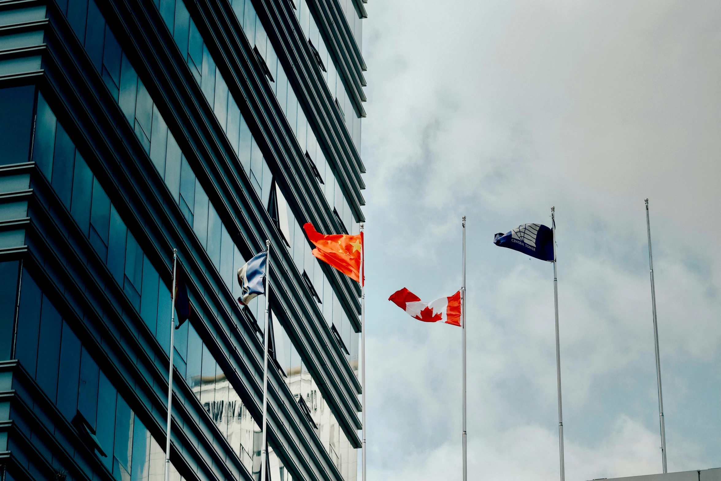 the flags of many different countries fly in front of a large building