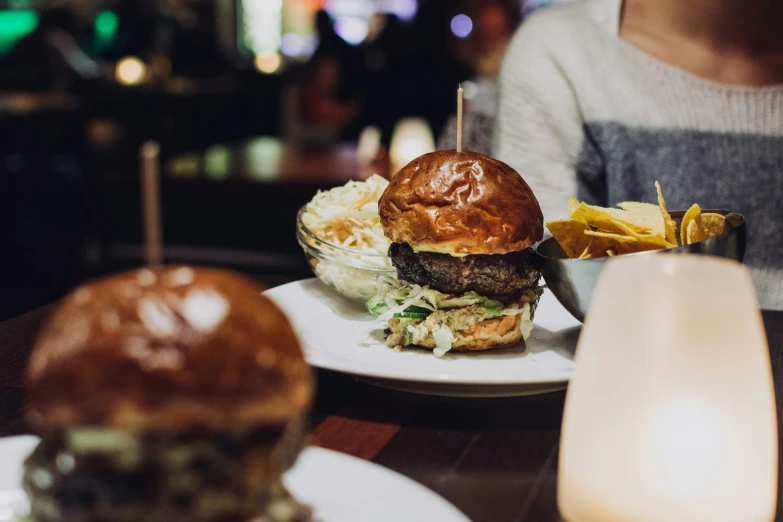 an up close picture of a hamburger and potato wedges