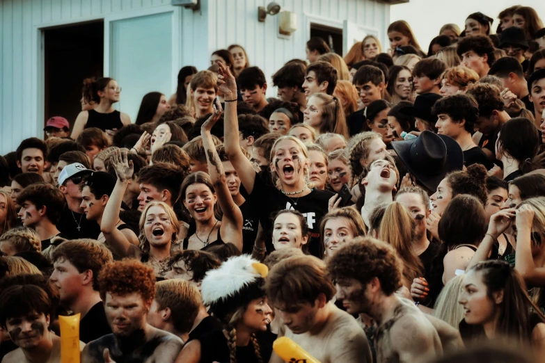 a group of people standing around each other in a crowd