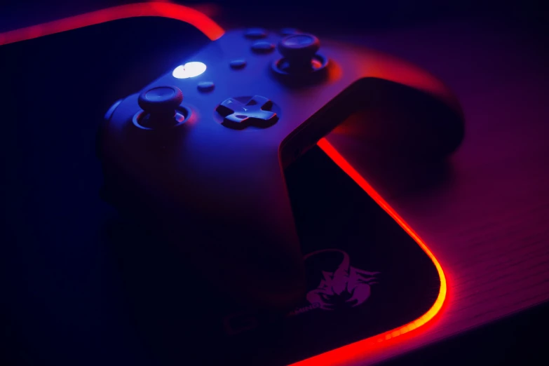 a close up of a gaming controller and a mouse