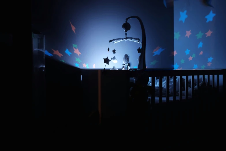 a night scene of a child's crib in a dark room