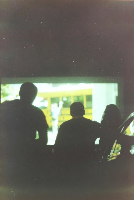 two people looking out of a car door