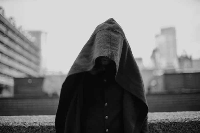 a black hooded object is covering the face of someone